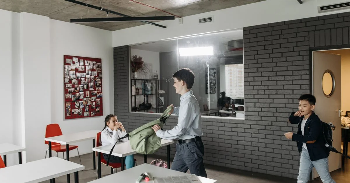 Enfants organisant des sacs à dos et des tâches dans un environnement de classe moderne.